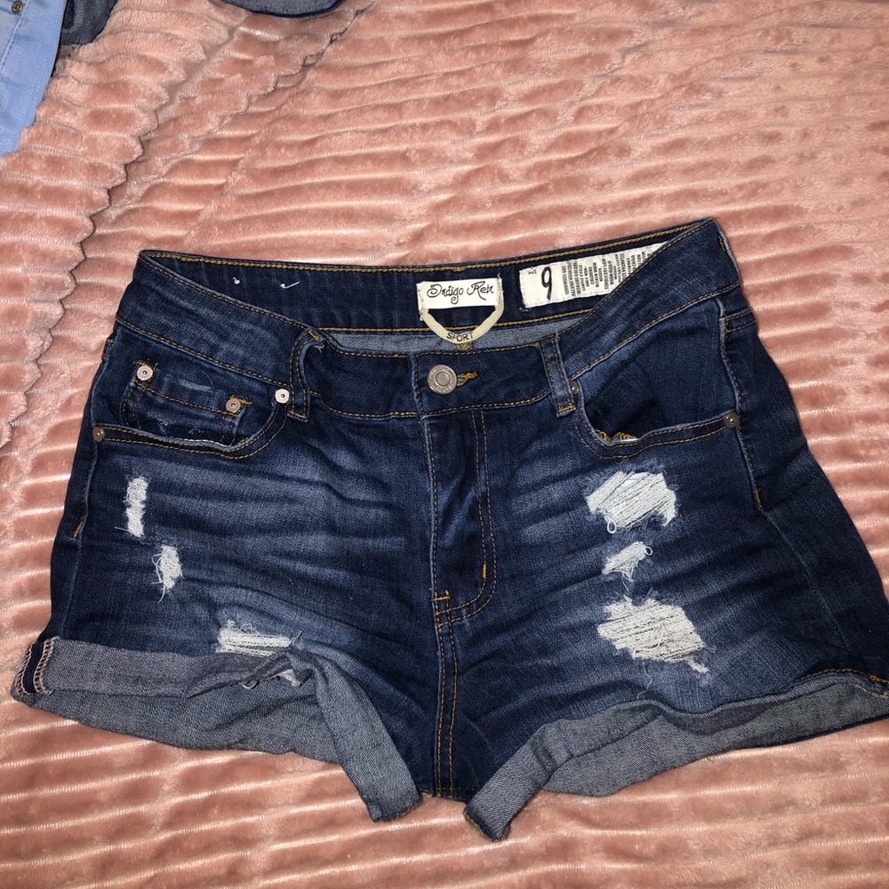 Dark washed ripped blue jean shorts